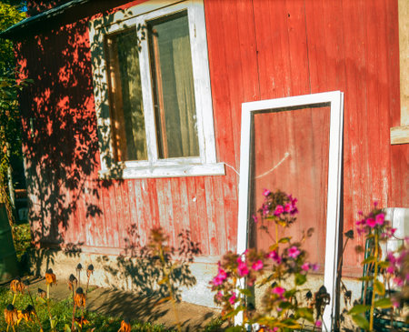 new pvc window leaned against the old wooden house, summertime outdoor shotの写真素材