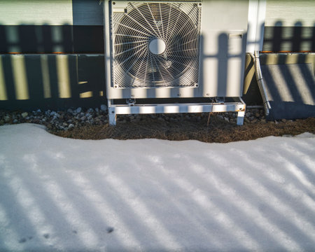 melting snow around air conditioner mounted outside of the house