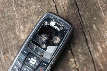 closeup of a smashed old mobile phone, shallow DOF