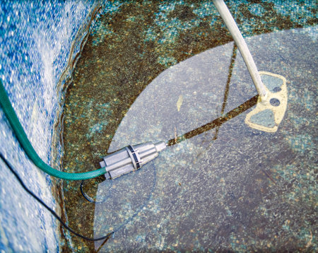 removing dirty plaque inside outdoor swimming pool, no people, high resolution imageの写真素材