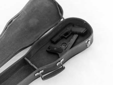 two pistols in an open violin case, in black and whiteの写真素材