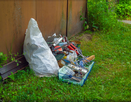 a pile of household garbage left outside of a metal garage, no peopleの写真素材