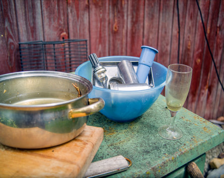washing a metal mincer and dirty dishes outdoor, no peopleの写真素材