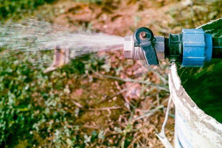 a slightly filtered image of an outdoor broken water tap, no peopleの写真素材