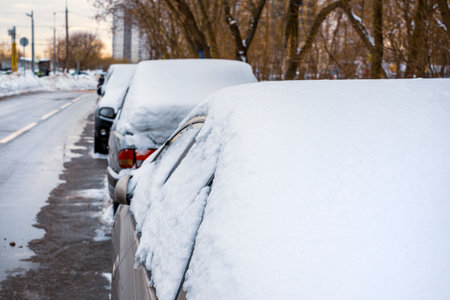 cars parked on the street and covered with snow, city sceneの写真素材