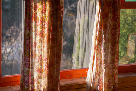 crumpled colorful curtains on the window, sunny day indoors shot