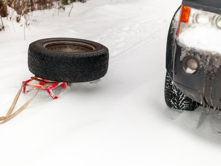 a car in the snow and a spare tire on the sledge, winter sceneの写真素材