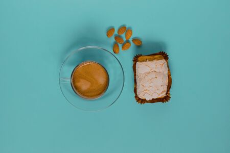 A glass Cup of black coffee with merinque cake and almond. Top view.の写真素材