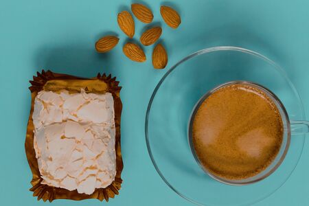 A glass Cup of black coffee with merinque cake and almond. Top view.の写真素材