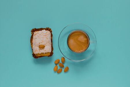 A glass Cup of black coffee with merinque cake and almond. Top view.の写真素材