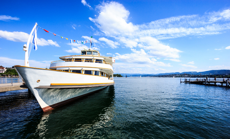 Beautiful Summer Sunny day view of Zurichsee (Lake Zurich) with cruise ship at the Zurich pier and blank space on the right side, Zurich, Switzerland, Europe.の写真素材
