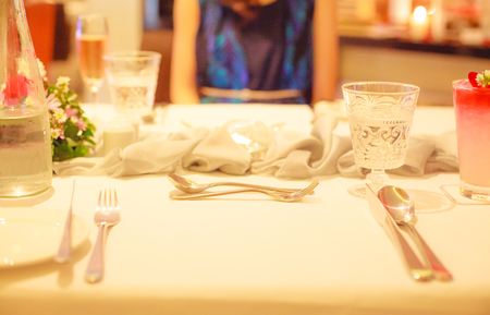 Romantic luxurious lunch or dinner table, dating with wife or girlfriend, anniversary surprise meal with blurred woman background. Celebration theme conceptの写真素材