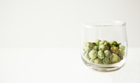 green roasted wasabi bean nuts dessert snack in a glass on white background.の写真素材