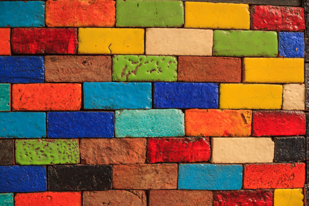 abstract aged multicolored painted baked earthen clay brick blocks, colorful architectural structure...