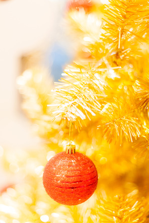 Glittering Bauble with Glowing Sparkling Gold defocused Light (bokeh) Illumination background with decorated Christmas Tree. Special Holidays, Festival design decoration, New Year Celebration, Party.の写真素材