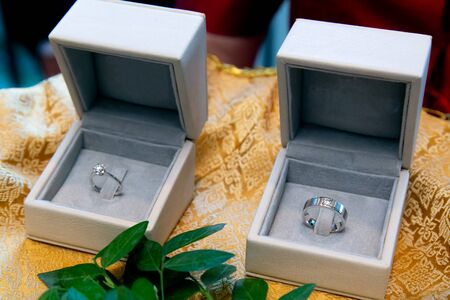 Diamond Engagement Rings with European Design in cushion boxes used in moment of exchanging (giving and receiving) rings during traditional marriage ceremony. Fine Jewelry in Wedding Ceremony Customs.の写真素材