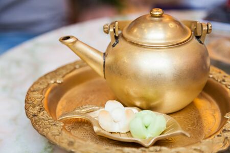 Afternoon Tea with Traditional Thai Klip Lamduan (Kleeb Lamduan) shortbread cookies with three petal...