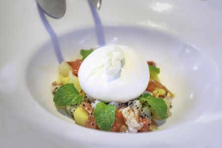 Fresh mozzarella Ball (Truffle Burrata), buttery cream and milky freshness within, accompanied by salads or bread. Made of Pasteurized Cowâs milk, Heavy Cream, Vinegar, Enzyme, Black Truffles and Saltの写真素材
