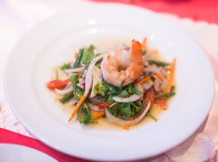 Selective Focused Traditional Asian Food: Thai Spicy Seafood Salad, most favorite and famous Thai street fast food dish commonly served as street food and at casual local eateries in Thailandの写真素材