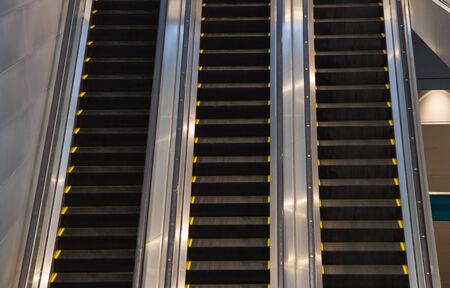 Escalators in subway train station towards upper levels, used in places where lifts would be...