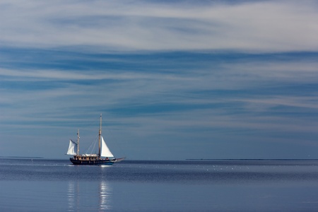 Lonely sailboat at seaの写真素材