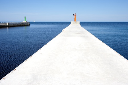View of the lighthouse, a boat and the seaの写真素材