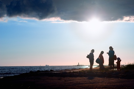 People walking on the sea at the mouth of the riverの写真素材