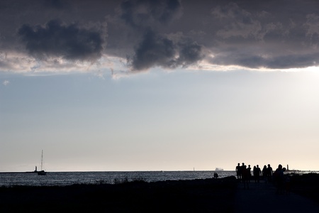 People walking on the sea at the mouth of the riverの写真素材