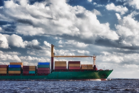 Ship with containers out into the open seaの写真素材