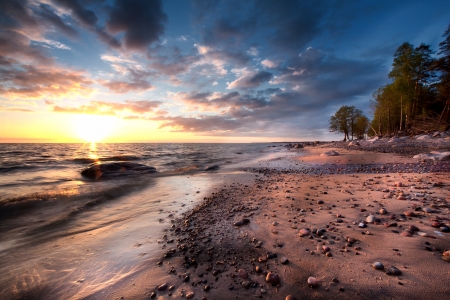Sandy beach with rocks at the seaの写真素材