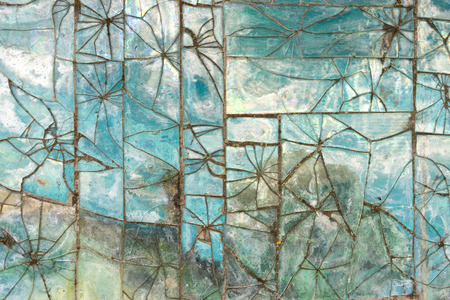 Patterns of broken glass tile on the wall