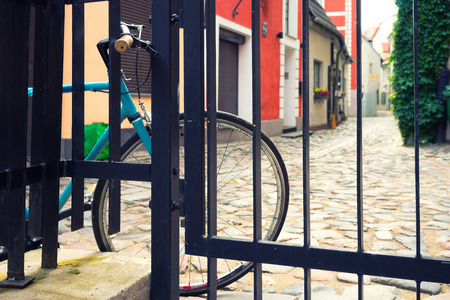 Cyclists at the fence in the old town. Vecriga, Latviaの写真素材