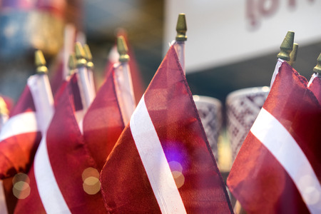 Latvian national flags in a shop window. Riga, Latviaの写真素材