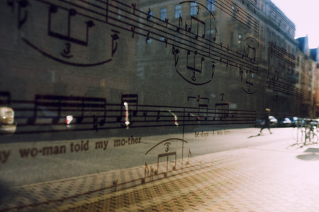 City and pedestrians at sunrise reflected in the window with notesの写真素材