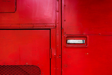 Aboard a red fire truck with doors and chrome handles and protective grilleの写真素材