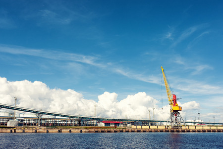 Cargo crane in the port of the Baltic against the blue sky in summer. Ventspilsの写真素材