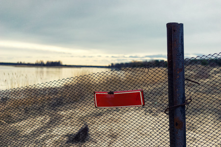 Red prohibiting sign on a fence at a private property near the lake. Latviaの写真素材