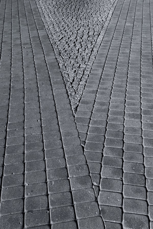 Diagonal lines and gray paving stones of the pavement in the cityの写真素材