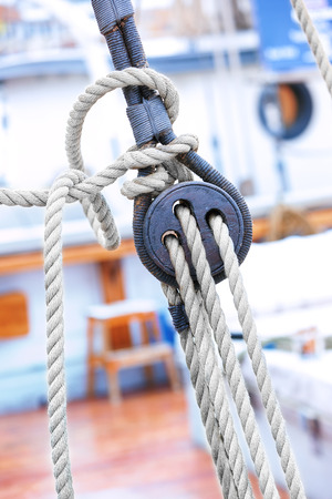 Ropes and wooden fixing arrangements on a large sailboatの写真素材