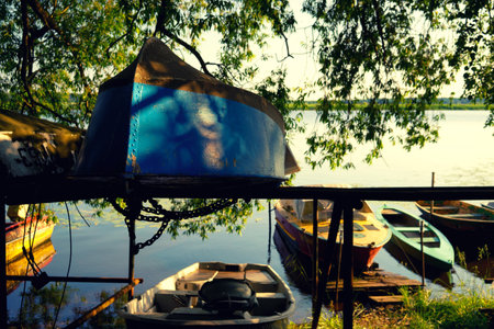 Latvia, Riga. July 2015. Old boats on the coast and in the river among the trees in the morningのeditorial素材