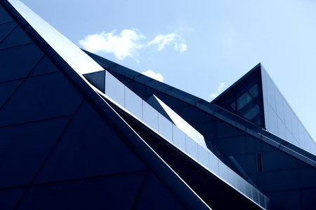 Latvia, Riga. July 2015. Modern building of the National Library in Riga of glass and concrete on a background of blue sky and cloudsのeditorial素材
