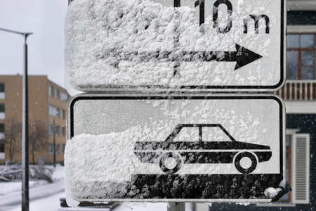 Latvia, Riga. Road signs Parking under snow in the winter at the crossroadsの写真素材