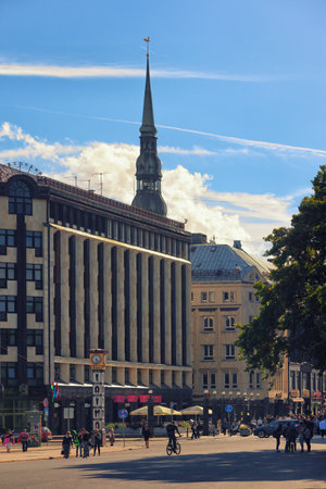 Riga, Latvia Â· September 2016: Life in the capital of Latvia in Riga area with the famous clock and spire of the Cathedral of St. Peter in early autumnのeditorial素材