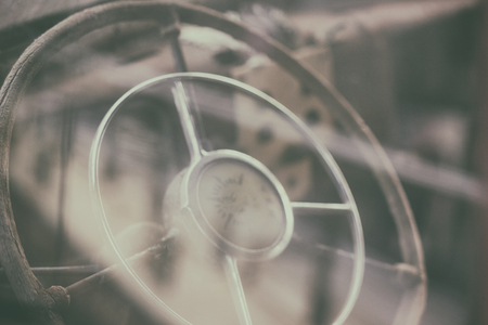 Wooden steering wheel vintage car through the glass glare in a romantic styleの写真素材
