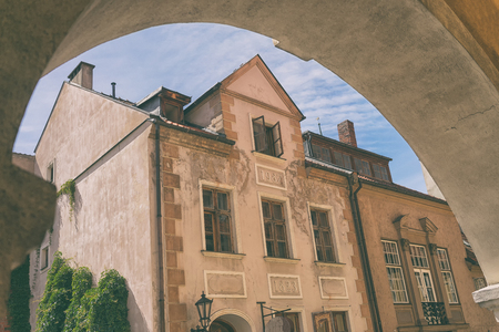 Old house with open Windows in the sky in the arch in the Latvian capital Rigaの写真素材