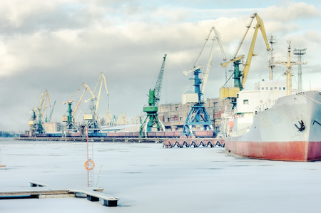 Cargo trade port on the frozen river Daugava in Riga during unloading and loading of railway carsの写真素材