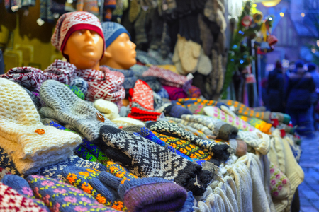 Woolen scarves and mittens with a national Latvian design in a stall at the Christmas Fair in Rigaの写真素材