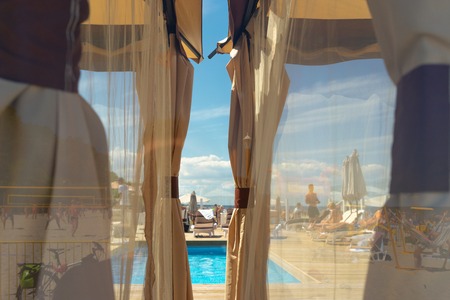 Closed beach by the sea with a swimming pool a place of rest on a sunny summer day through...