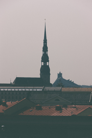Peters Cathedral and the Latvian National Library in Riga on a background of autumn cloudy sky