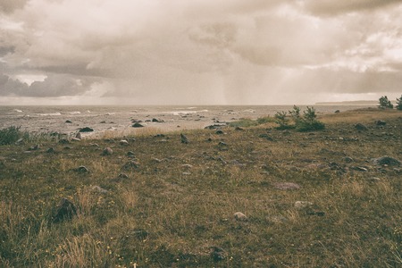 High Baltic Sea coast with rocks in the north in a strong wind.の写真素材
